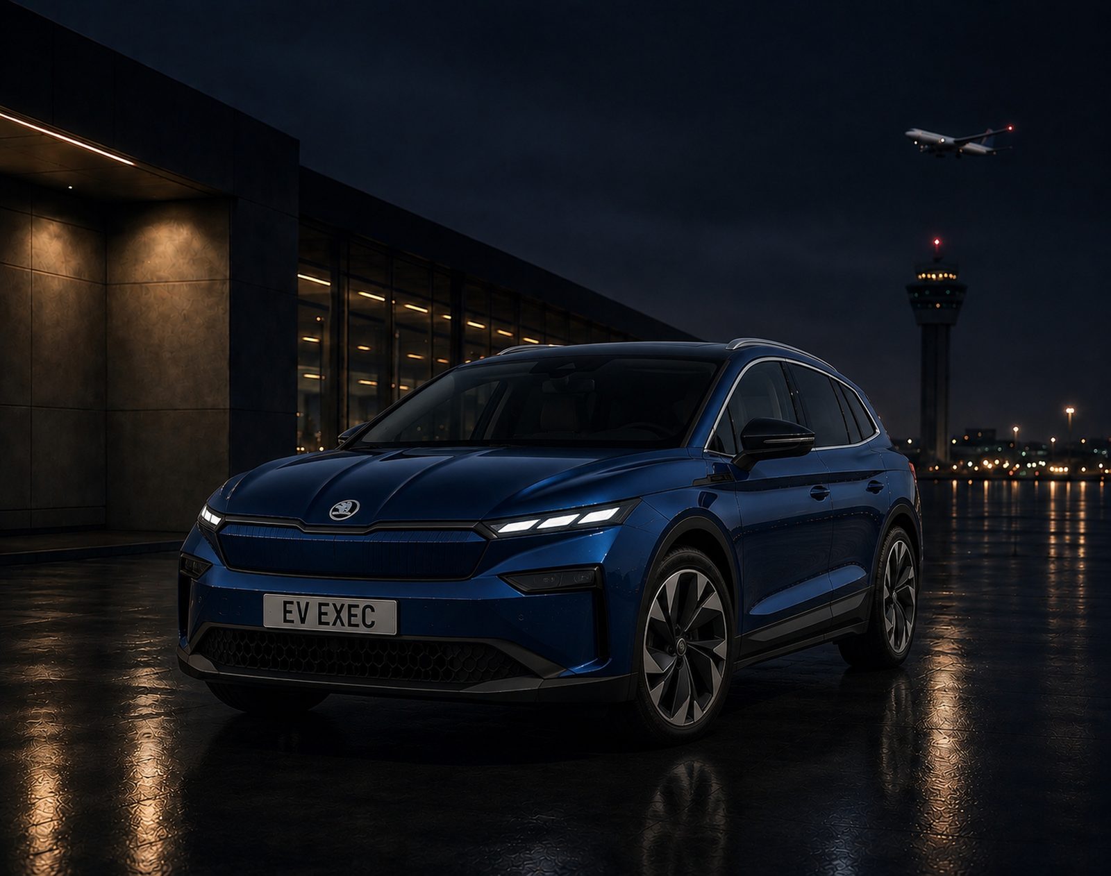 EV Exec blue Skoda Enyaq parked at night with airport control tower in the background
