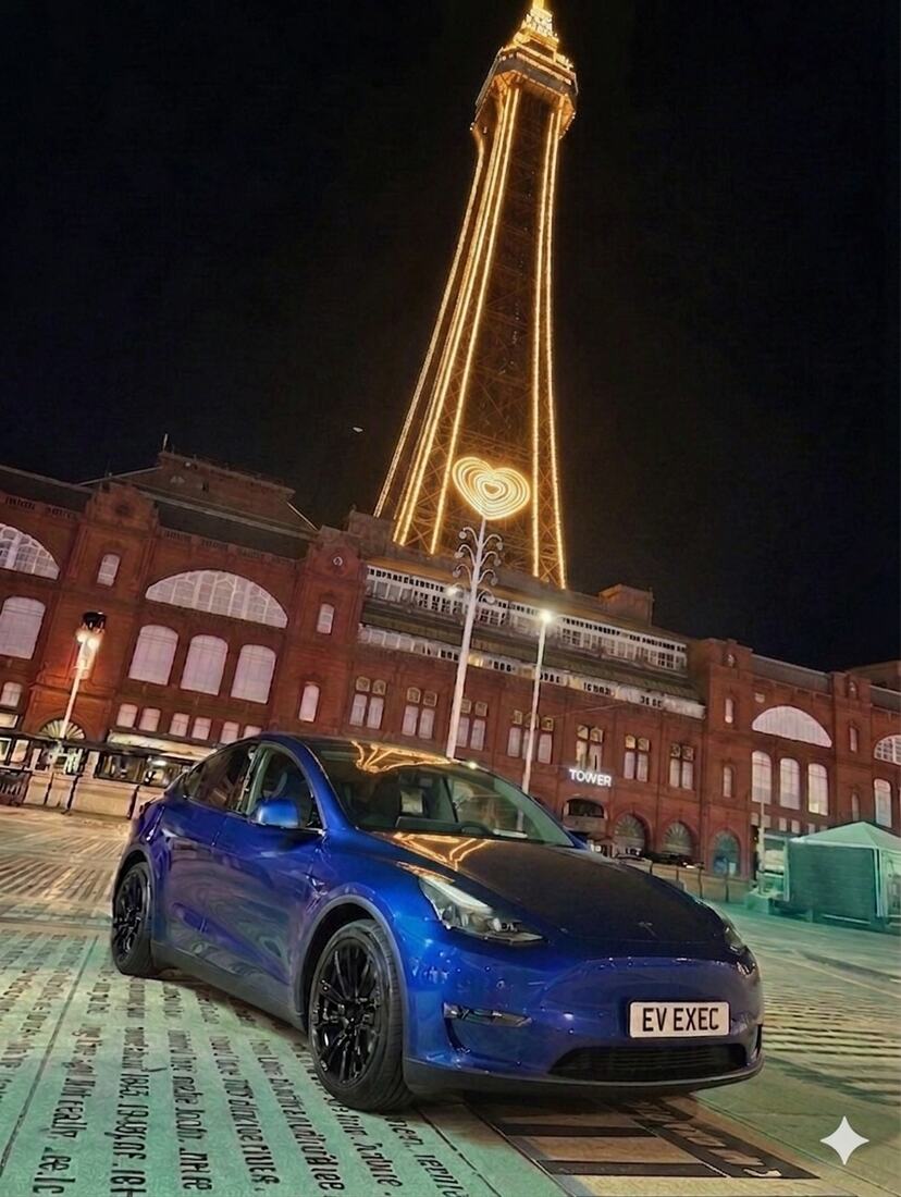 EV Exec Tesla Model Y on Blackpool promenade beneath the Tower at night